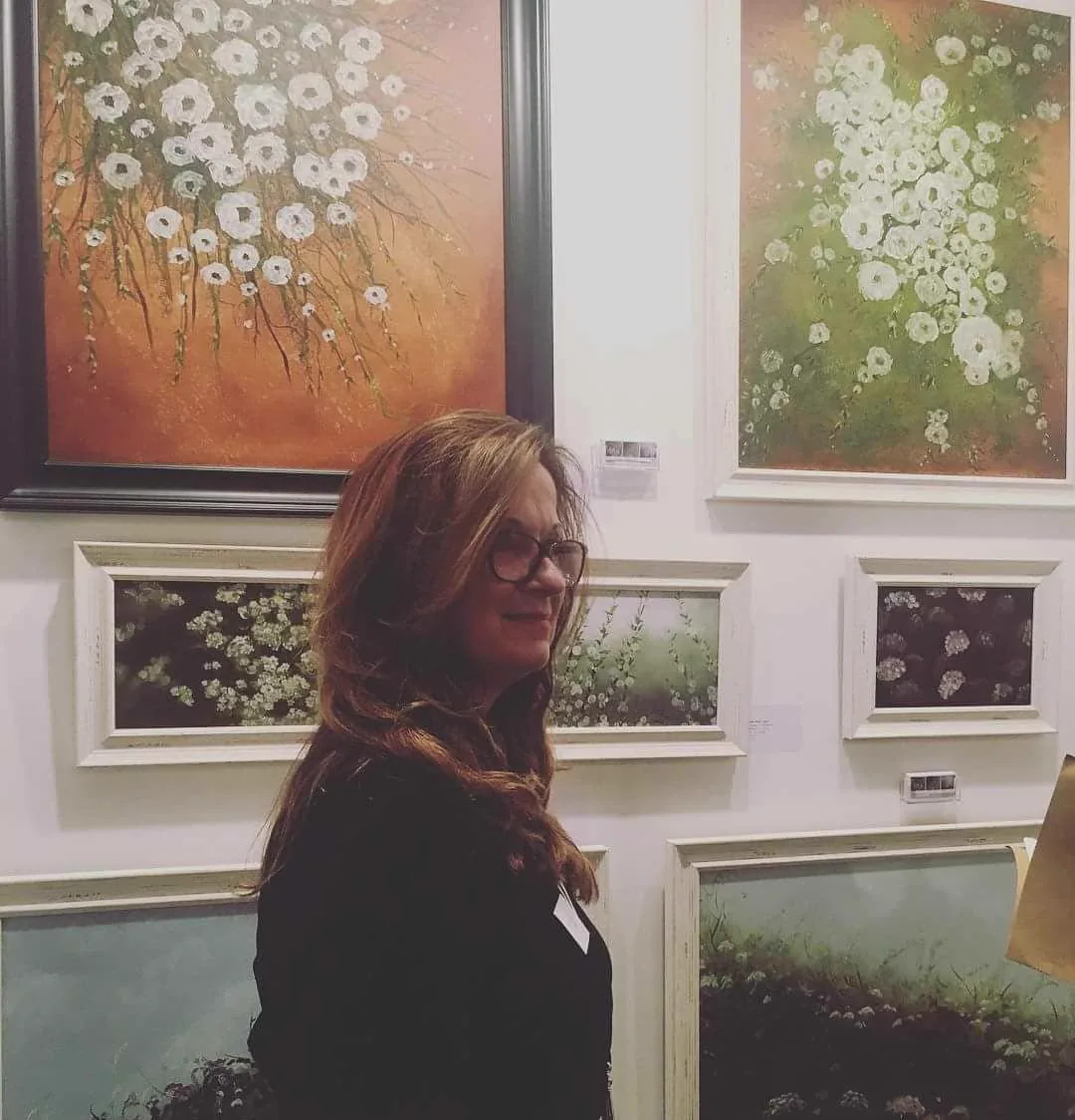 Julia beside her paintings at the Parallax Art Fair