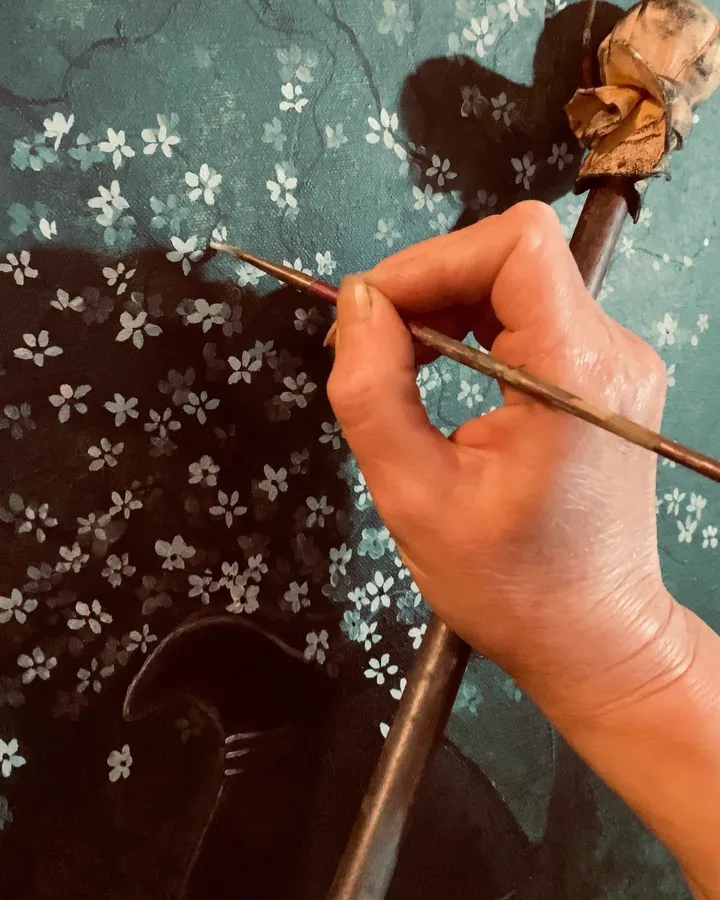 Julia painting flower detail on a canvas